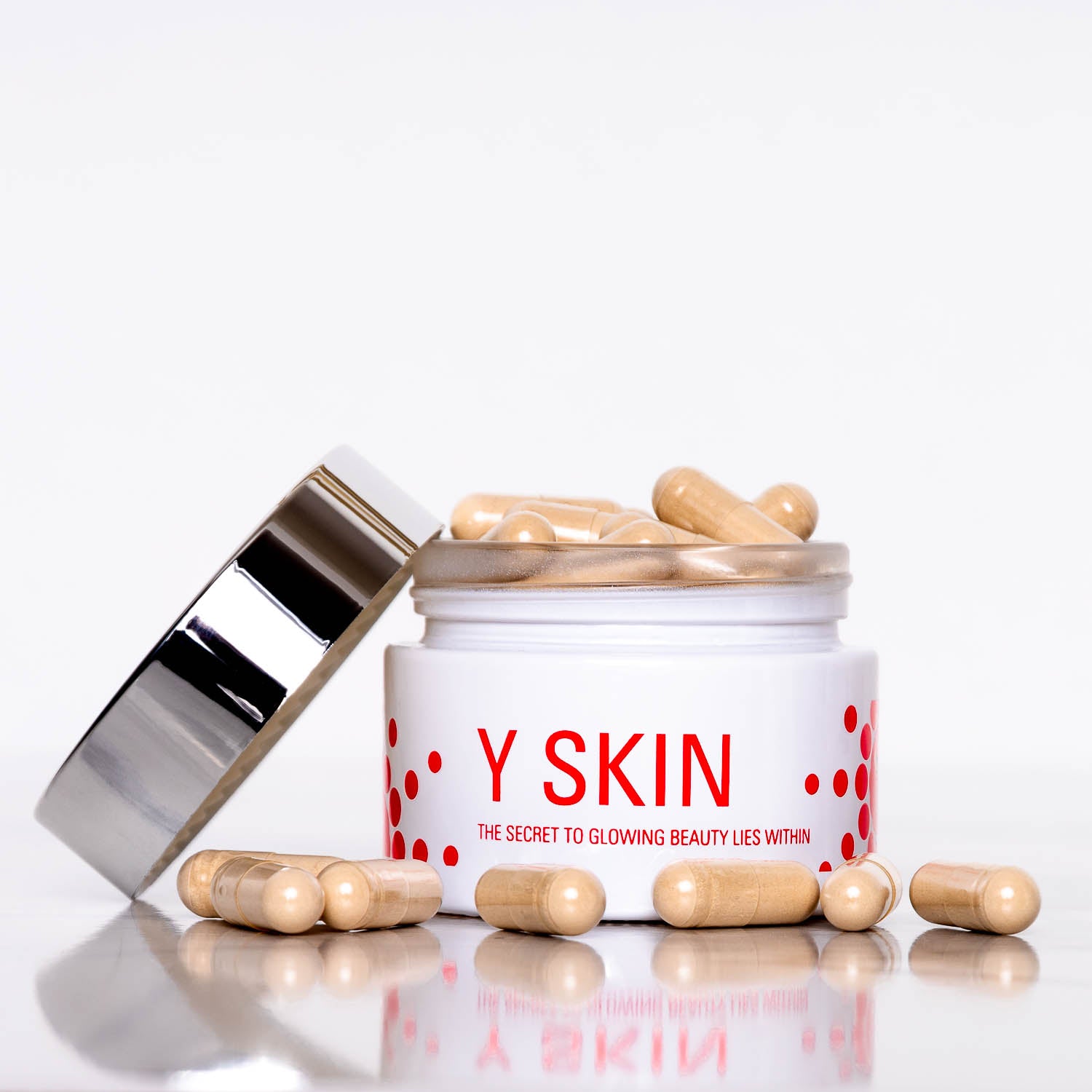Open jar of Y SKIN supplement capsules with the lid resting to the side, highlighting the clean, modern packaging design.